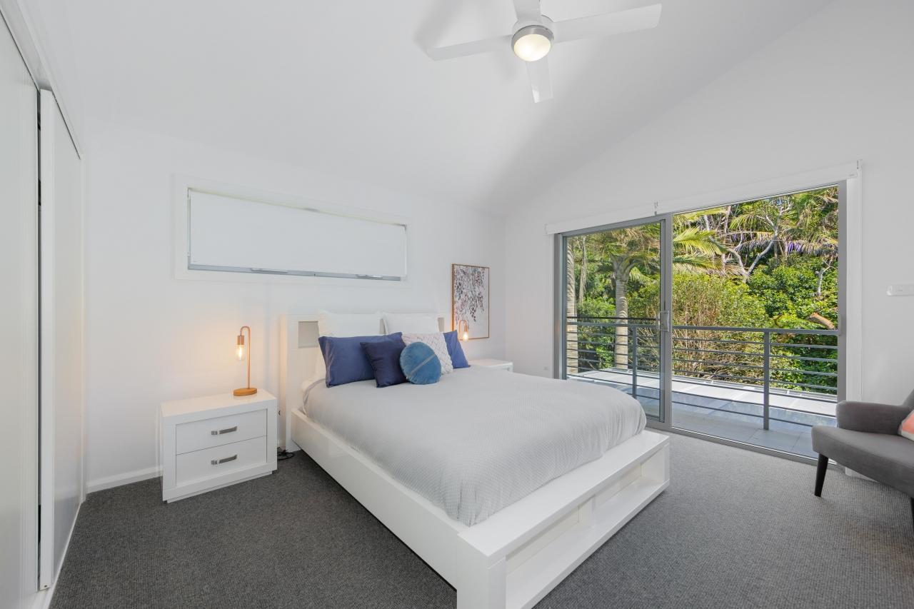 Second bedroom with queen bed, balcony overlooking backyard and reserve. Has split system air con and ceiling fan. upstairs.Laze at Lighthouse