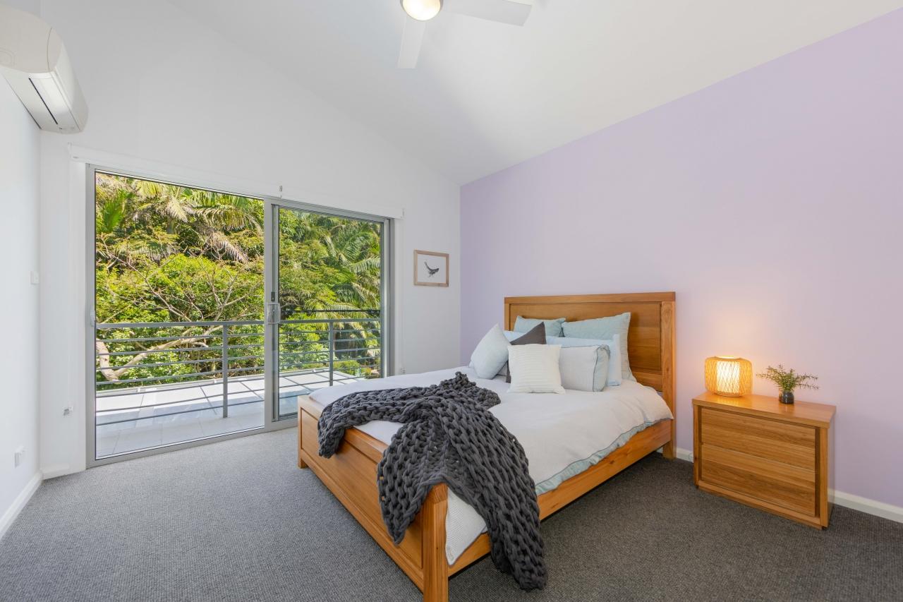 Third bedroom with queen bed, balcony overlooking backyard and reserve. Has split system air con and ceiling fan. Upstairs. Laze at Lighthouse