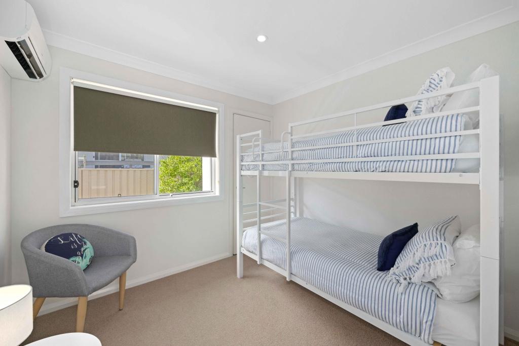 Bedroom with singe sized bunk beds with air con