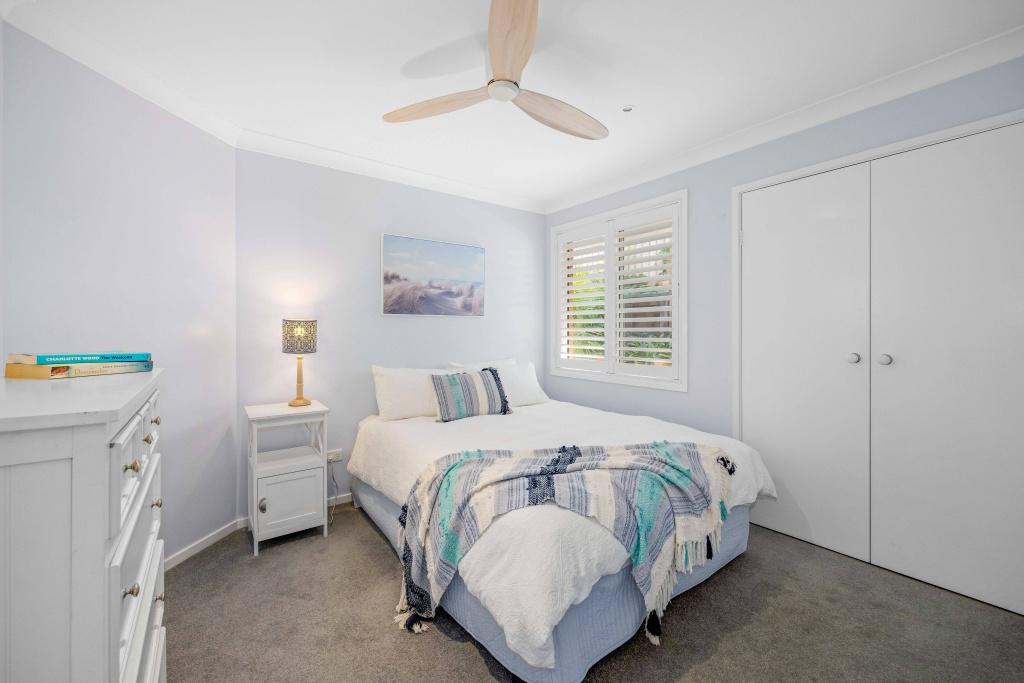 Second bedroom with queen bed and ceiling fan. Lighthouse Vaccay