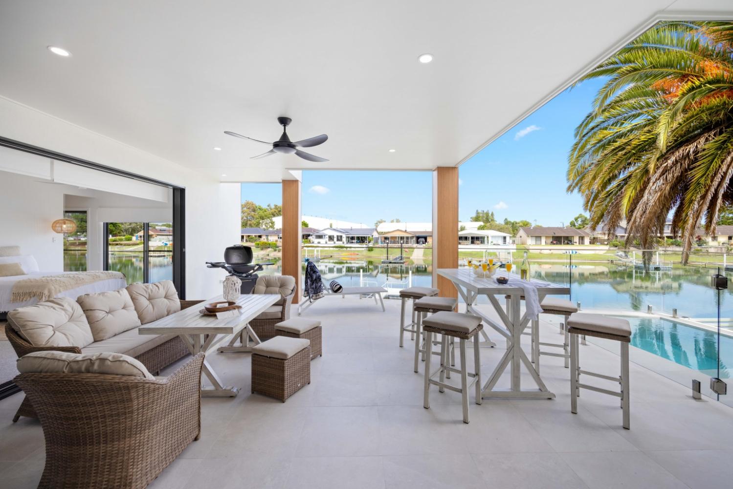 Outdoor living and dining overlooking pool and canals. Hamiltons
