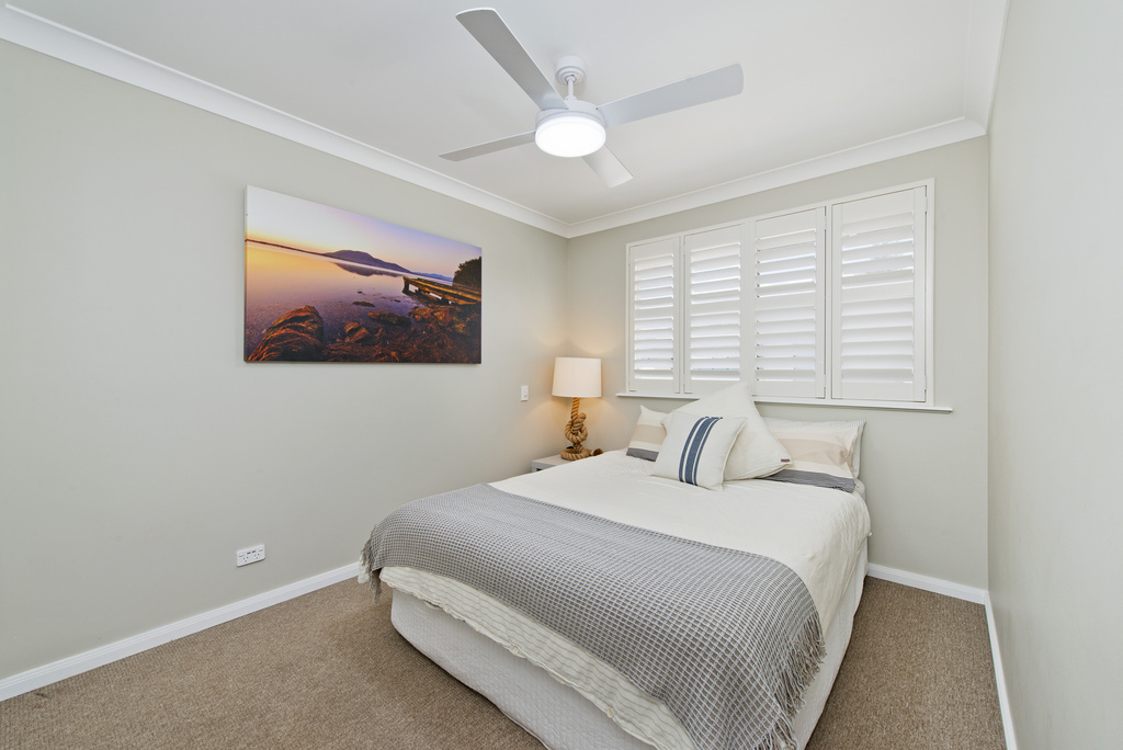 Second bedroom upstairs with queen bed and ceiling fan Apricari oasis by the sea Bonny Hills