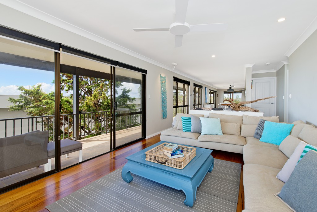 Living area with smart TV, ceiling fan and sliding doors out to balcony Apricari oasis by the sea Bonny Hills