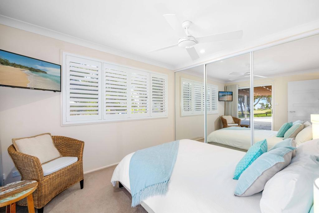 Downstairs bedroom with queen bed and ceiling fan Allure by the Sea