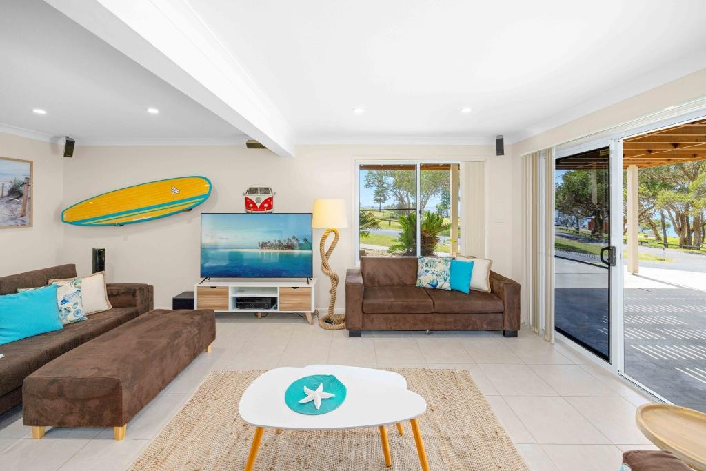 Downstairs living room with sofa bed, smart TV and sliding doors leading out to car port Allure by the Sea