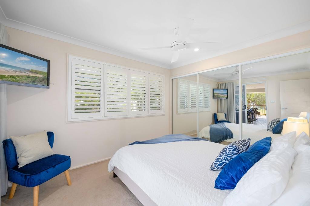 Upstairs bedroom with queen sized bed, ceiling fan and TV Allure by the Sea