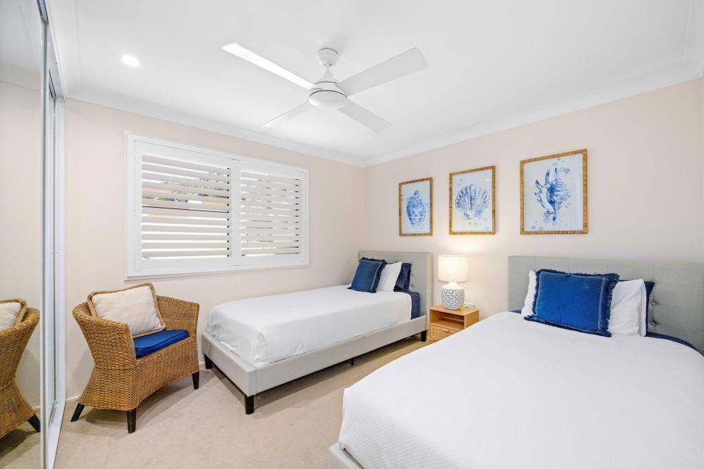 Downstairs bedroom with x2 single beds and ceiling fan Allure by the Sea