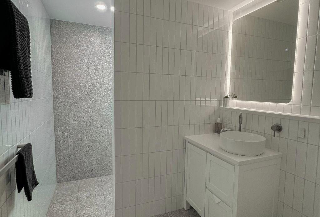 The recently rennovated bathroom is light, bright and airy and includes a self lit bathroom mirror