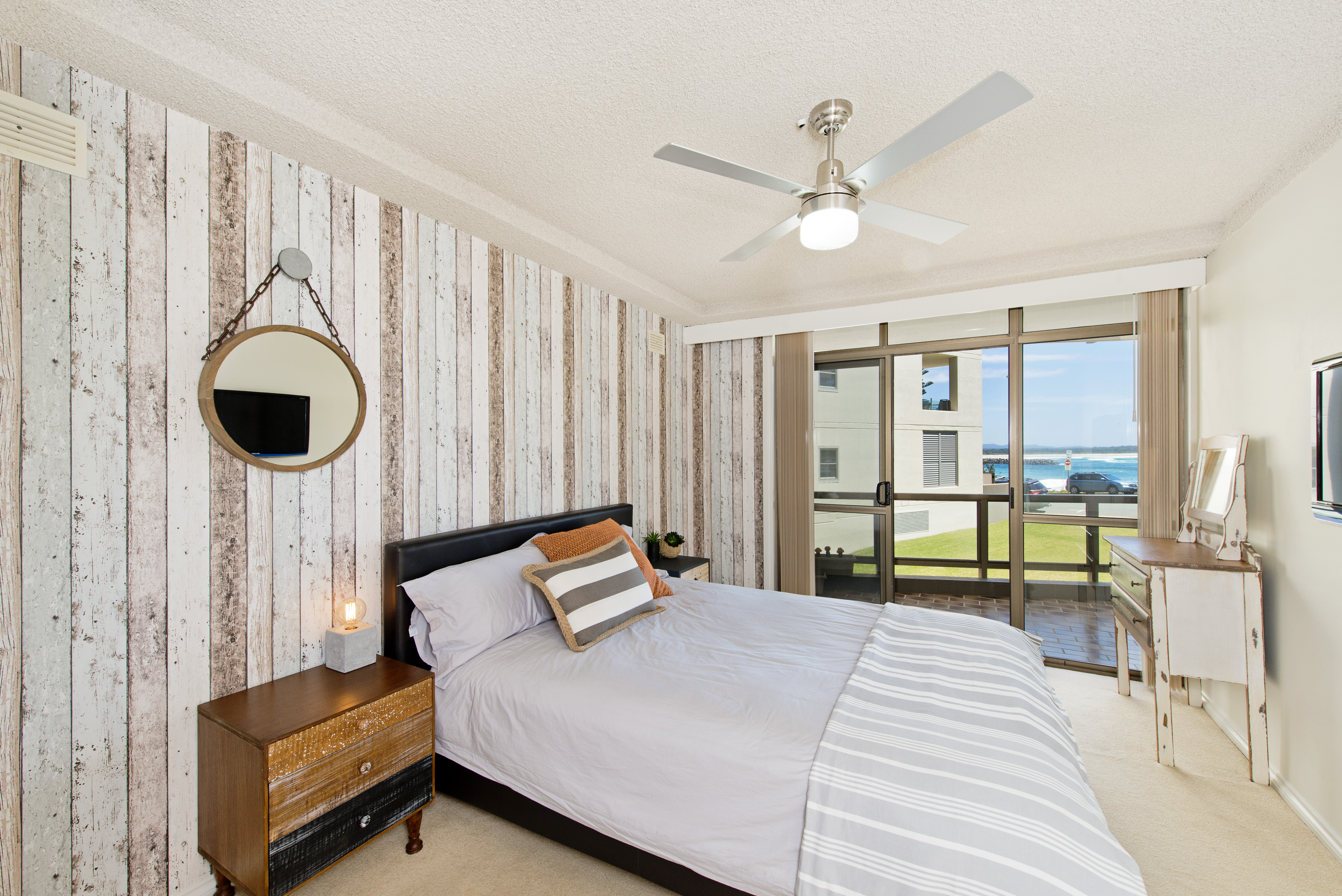 Second bedroom with queen bed, ocean views, TV and ceiling fan. Beauty at the Beach