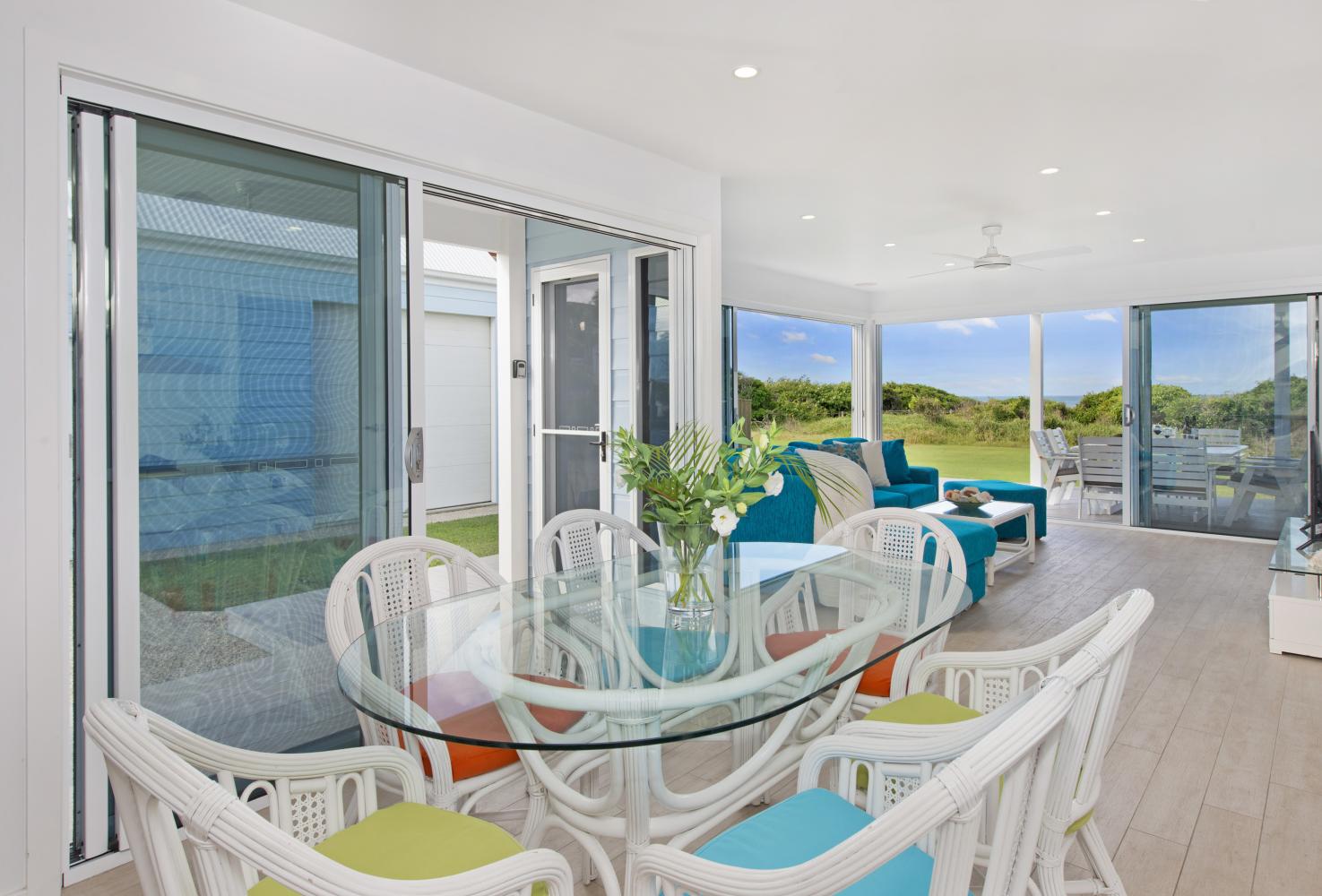 Open plan Dining, kitchen and lounge with aircon. Middle Rock Beach House
