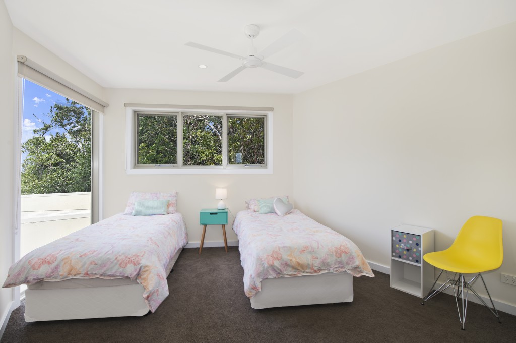 Fourth bedroom with x2 single beds and ceiling fan. Upstairs Kilala